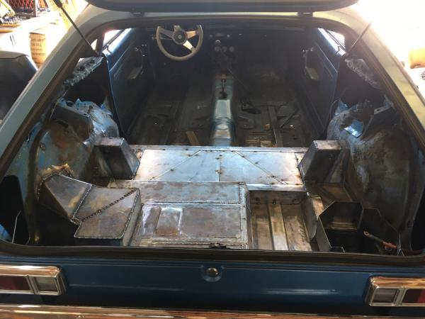 custom metal floor covering a JAZ 12-gallon fuel cell in a Ford Pinto